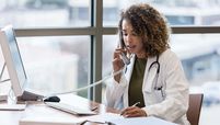 doctor on phone at desk stock image