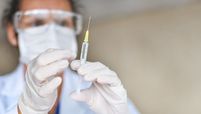 doctor holding vaccine stock image