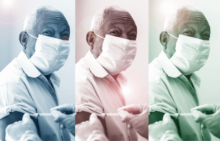 An older man wearing a mask receiving a vaccine.